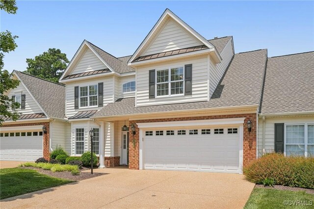 8156 Cool Summer Dr, Mechanicsville, VA 23111 - view of front of property featuring a standing seam roof, concrete driveway, brick siding, a metal roof, and roof with shingles