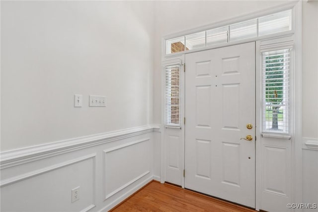 8156 Cool Summer Dr, Mechanicsville, VA 23111 - foyer entrance featuring wainscoting, light wood-style floors, and a decorative wall