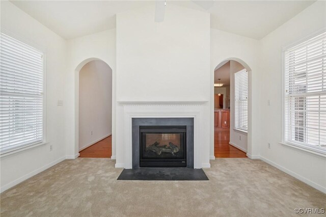 8156 Cool Summer Dr, Mechanicsville, VA 23111 - unfurnished living room with arched walkways, carpet, and a fireplace with flush hearth