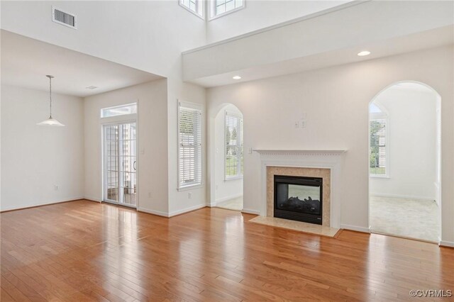 8156 Cool Summer Dr, Mechanicsville, VA 23111 - unfurnished living room featuring wood finished floors, a high end fireplace, arched walkways, and recessed lighting