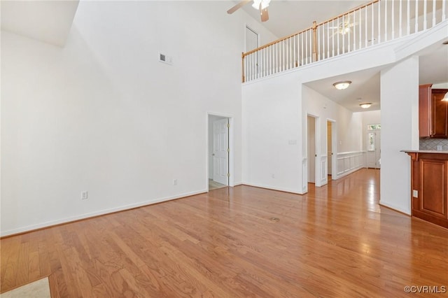 8156 Cool Summer Dr, Mechanicsville, VA 23111 - unfurnished living room featuring a towering ceiling, light wood-type flooring, and ceiling fan