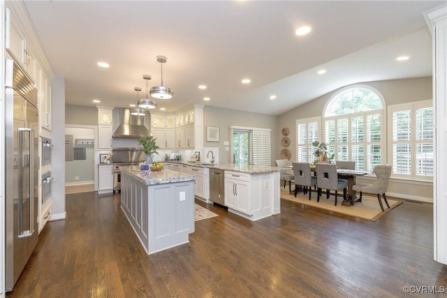 14006 Riverdowns N Mews, Midlothian, VA 23113 - kitchen featuring wall chimney exhaust hood, a peninsula, premium appliances, a sink, and baseboards