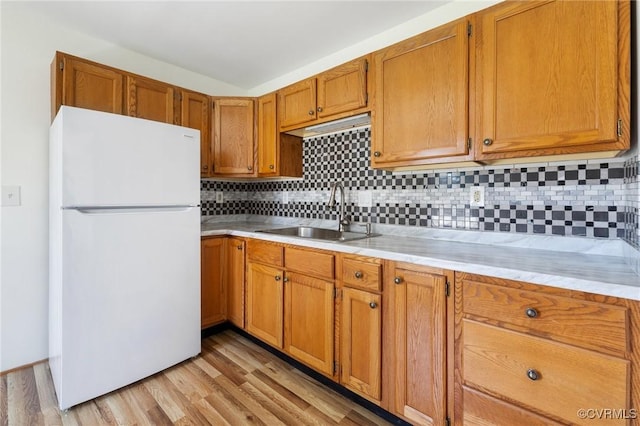 1312 St Michaels Ln, Richmond, VA 23229 - kitchen with freestanding refrigerator, light countertops, tasteful backsplash, light wood finished floors, and brown cabinetry