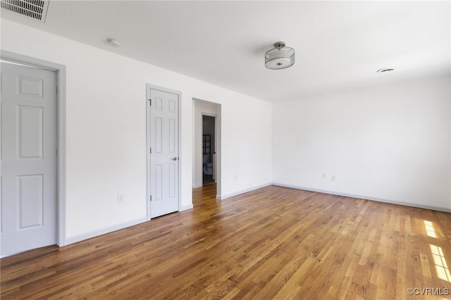 1312 St Michaels Ln, Richmond, VA 23229 - empty room with a smoke detector and wood finished floors