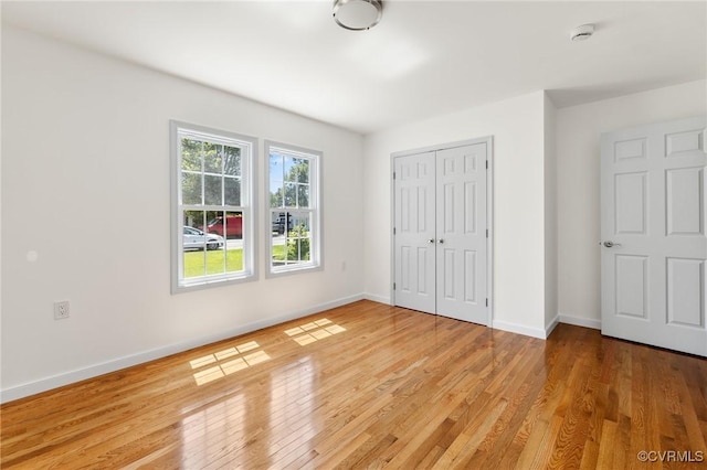 1312 St Michaels Ln, Richmond, VA 23229 - unfurnished bedroom with light wood-style flooring and a closet