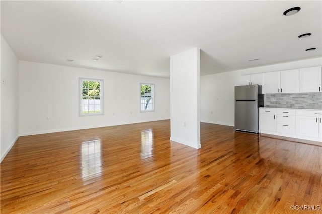 1312 St Michaels Ln, Richmond, VA 23229 - unfurnished living room with light wood-style flooring