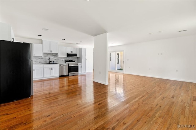 1312 St Michaels Ln, Richmond, VA 23229 - unfurnished living room featuring light wood finished floors