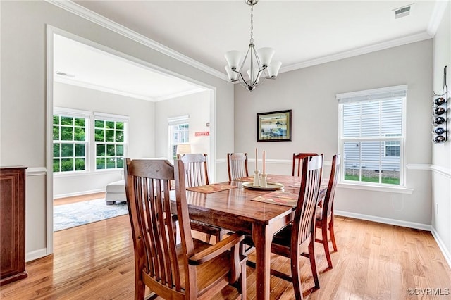 9951 Orchard Meadow Rd, Mechanicsville, VA 23116 - dining room with light wood-style flooring, a chandelier, and crown molding