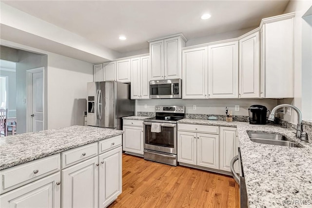 9951 Orchard Meadow Rd, Mechanicsville, VA 23116 - kitchen featuring appliances with stainless steel finishes, white cabinetry, light wood-style floors, and recessed lighting