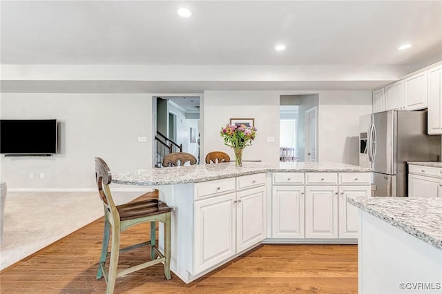9951 Orchard Meadow Rd, Mechanicsville, VA 23116 - kitchen featuring stainless steel refrigerator with ice dispenser, a breakfast bar, white cabinets, a center island, and recessed lighting