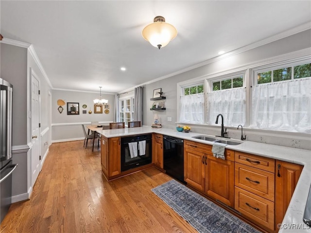 1125 Royal Ridge Rd, Chesterfield, VA 23114 - kitchen with black appliances, brown cabinets, light countertops, plenty of natural light, and crown molding