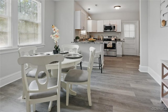 3928 E Broad Rock Rd, Richmond, VA 23224 - dining area with baseboards and wood finished floors