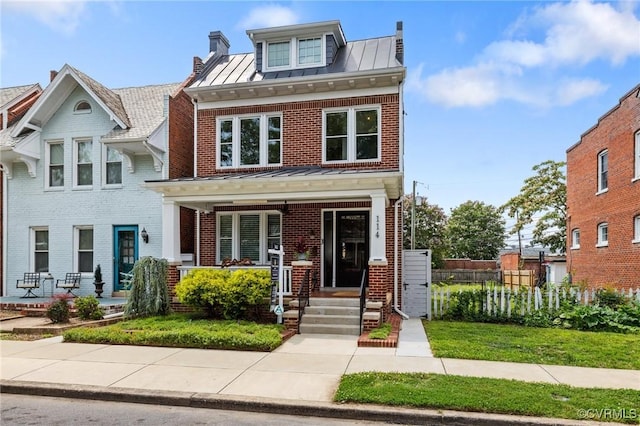 114 S Colonial Ave, Richmond, VA 23221 - view of front of house featuring brick siding, a porch, a standing seam roof, and a metal roof