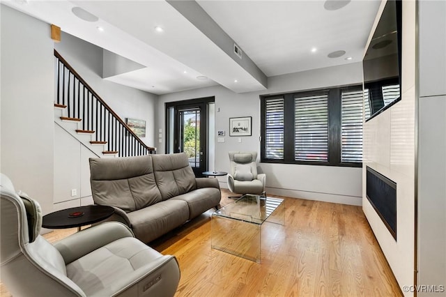 114 S Colonial Ave, Richmond, VA 23221 - living room with light wood-type flooring, a large fireplace, stairs, and recessed lighting