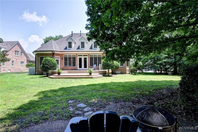 2520 Nathaniell Powell Rd, Williamsburg, VA 23185 - rear view of house with an outdoor fire pit, brick siding, french doors, and a lawn