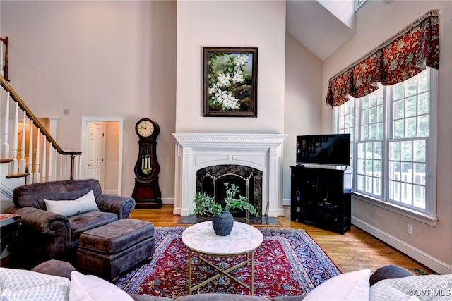 2520 Nathaniell Powell Rd, Williamsburg, VA 23185 - living room with wood finished floors, stairway, high vaulted ceiling, and a high end fireplace