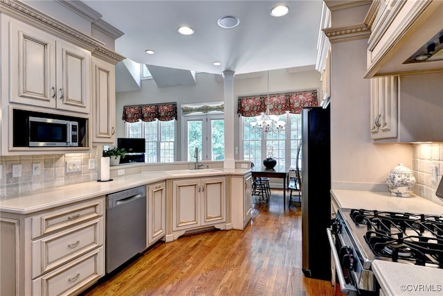 2520 Nathaniell Powell Rd, Williamsburg, VA 23185 - kitchen featuring stainless steel appliances, custom range hood, cream cabinets, light countertops, and a chandelier