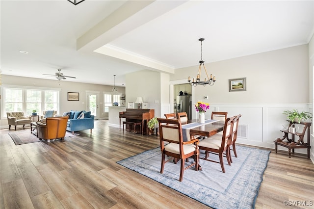 12025 Autumn Knoll Dr, Mechanicsville, VA 23116 - dining space featuring a chandelier, wood finished floors, wainscoting, and a ceiling fan