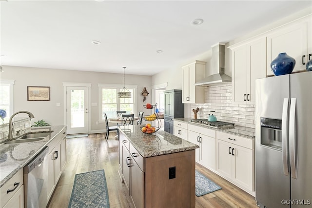12025 Autumn Knoll Dr, Mechanicsville, VA 23116 - kitchen featuring stainless steel appliances, wall chimney range hood, a kitchen island, decorative backsplash, and white cabinetry