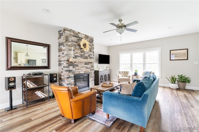 12025 Autumn Knoll Dr, Mechanicsville, VA 23116 - living room with wood finished floors, a ceiling fan, and a stone fireplace