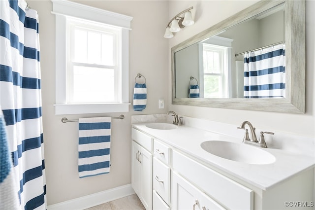 12025 Autumn Knoll Dr, Mechanicsville, VA 23116 - bathroom featuring double vanity and healthy amount of natural light