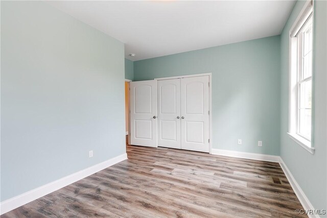 8315 Namozine Rd, Amelia Courthouse, VA 23002 - unfurnished bedroom featuring wood finished floors, a closet, and baseboards