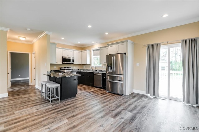 8315 Namozine Rd, Amelia Courthouse, VA 23002 - kitchen with stainless steel appliances, wood finished floors, ornamental molding, a peninsula, and baseboards