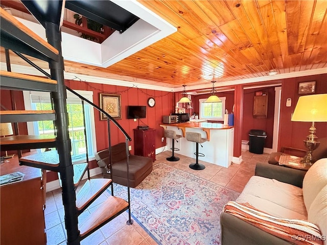 12509 Sam Snead Hwy, Warm Springs, VA 24484 - living room with light tile patterned floors, wood ceiling, stairs, and crown molding