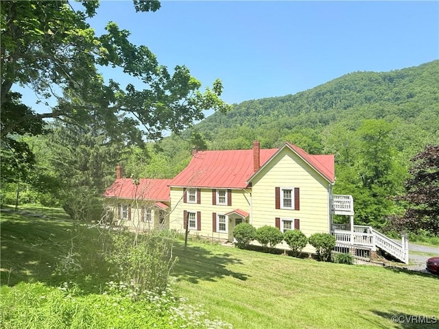 12509 Sam Snead Hwy, Warm Springs, VA 24484 - view of front of home featuring a chimney, a front yard, a forest view, and a mountain view