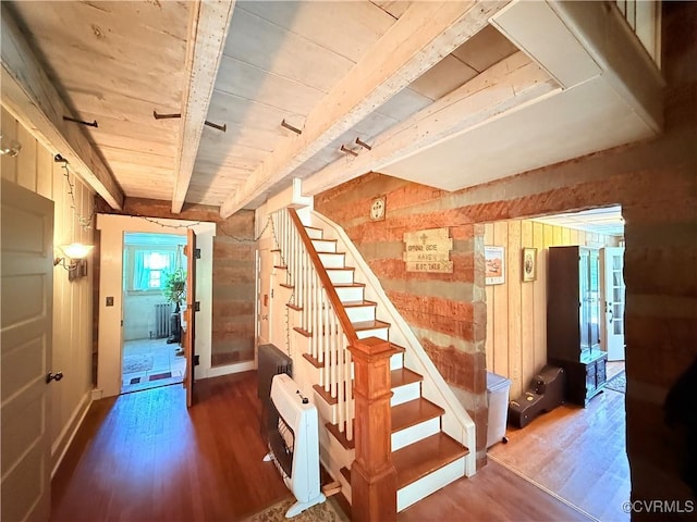 12509 Sam Snead Hwy, Warm Springs, VA 24484 - staircase featuring wood finished floors, wooden walls, heating unit, radiator, and wood ceiling with exposed beams
