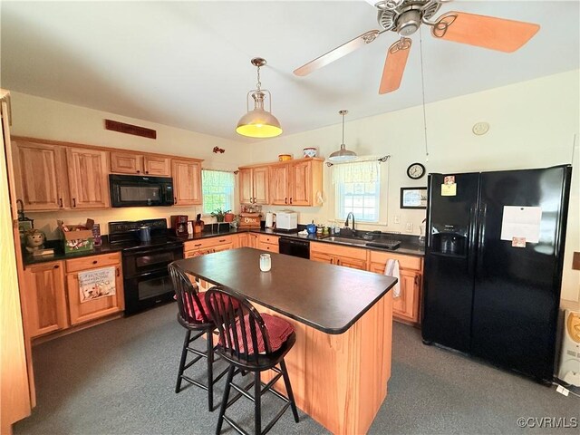 12509 Sam Snead Hwy, Warm Springs, VA 24484 - kitchen with black appliances, dark countertops, a kitchen breakfast bar, a center island, and ceiling fan