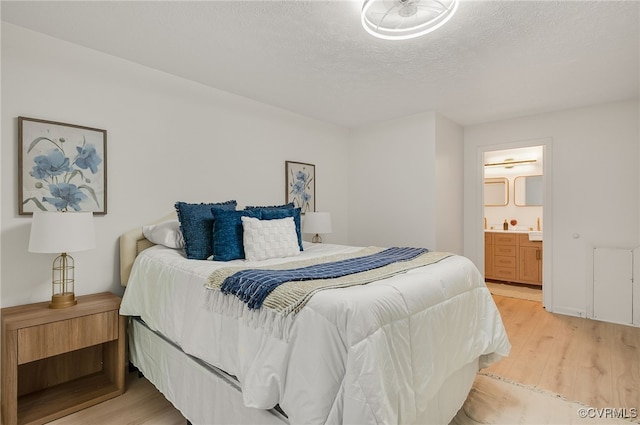 2106 Turtle Run Dr Unit 3, Henrico, VA 23233 - bedroom with light wood-style floors, ensuite bath, and a textured ceiling