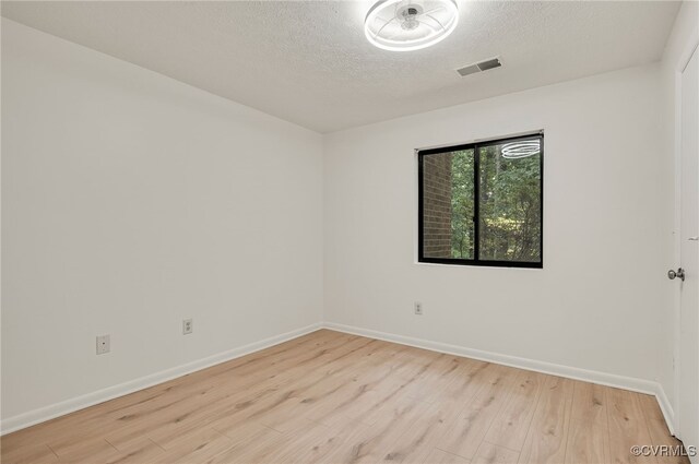 2106 Turtle Run Dr Unit 3, Henrico, VA 23233 - empty room with light wood-style flooring, baseboards, and a textured ceiling