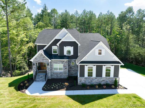12731 Dell Hill Ct, Chester, VA 23831 - view of front facade with stone siding, a front lawn, and board and batten siding
