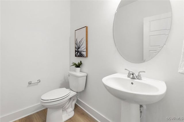 12731 Dell Hill Ct, Chester, VA 23831 - bathroom with baseboards, wood finished floors, toilet, and a sink