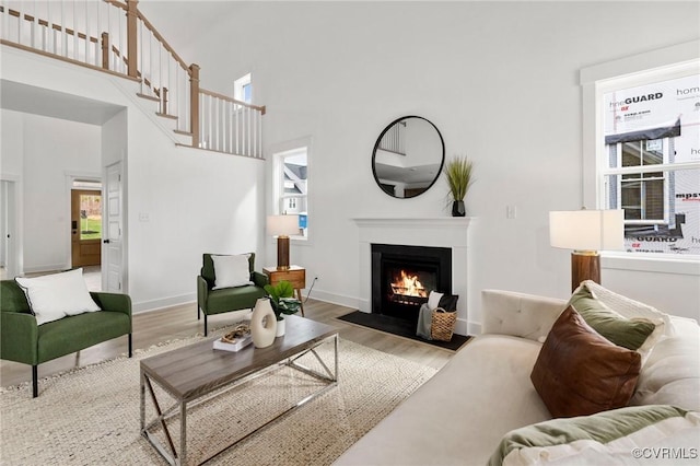 12731 Dell Hill Ct, Chester, VA 23831 - living room with wood finished floors, a fireplace with flush hearth, a high ceiling, and baseboards