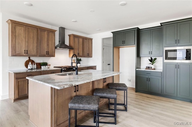 12731 Dell Hill Ct, Chester, VA 23831 - kitchen featuring wall chimney range hood, built in microwave, light wood-style flooring, and light stone countertops