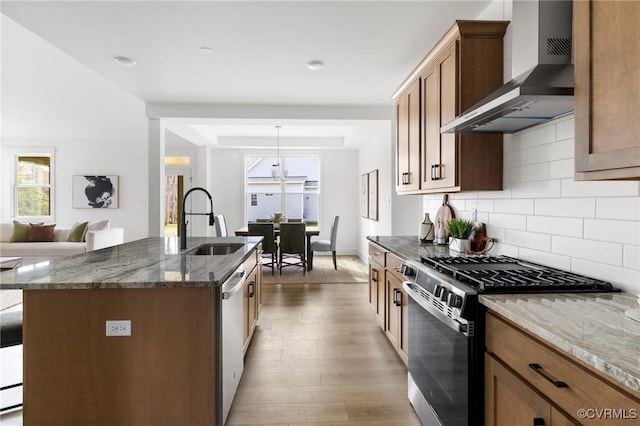 12731 Dell Hill Ct, Chester, VA 23831 - kitchen featuring wall chimney exhaust hood, appliances with stainless steel finishes, a sink, wood finished floors, and dark stone counters
