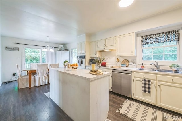 2301 White Chapel Rd, Lancaster, VA 22503 - kitchen featuring stainless steel dishwasher, dark wood-type flooring, light countertops, white oven, and a chandelier