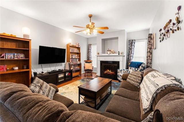 3321 Ceres Rd, Henrico, VA 23294 - living area featuring wood finished floors, a ceiling fan, and a warm lit fireplace
