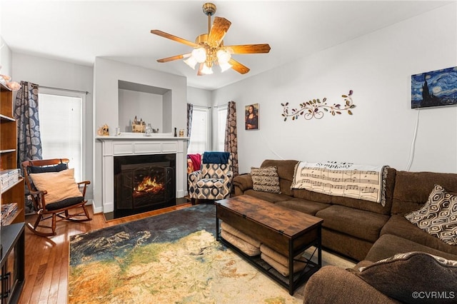 3321 Ceres Rd, Henrico, VA 23294 - living room featuring ceiling fan, a warm lit fireplace, wood-type flooring, and healthy amount of natural light