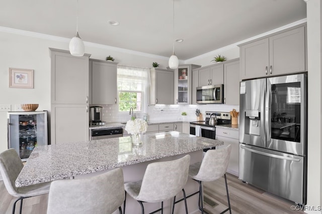15942 Fishers Green Dr, Chesterfield, VA 23832 - kitchen featuring stainless steel appliances, gray cabinets, wine cooler, light wood-style flooring, and decorative backsplash