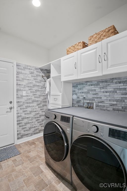 15942 Fishers Green Dr, Chesterfield, VA 23832 - laundry room featuring separate washer and dryer, cabinet space, and stone finish floors