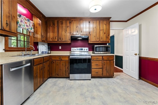 4337 Collingswood Dr, Chesterfield, VA 23832 - kitchen featuring appliances with stainless steel finishes, under cabinet range hood, light countertops, brown cabinets, and ornamental molding