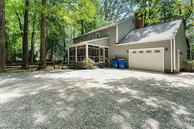 4337 Collingswood Dr, Chesterfield, VA 23832 - rear view of house featuring a sunroom, an attached garage, a chimney, driveway, and roof with shingles