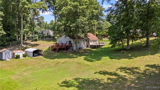 10050 S General Blvd, North Chesterfield, VA 23237 - view of grassy yard with a storage shed, a deck, a detached carport, and view of scattered trees