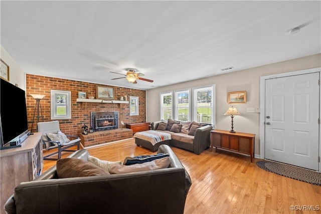 10050 S General Blvd, North Chesterfield, VA 23237 - living room featuring ceiling fan, a brick fireplace, light wood finished floors, and brick wall