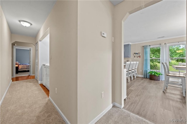 10050 S General Blvd, North Chesterfield, VA 23237 - hallway featuring washer and dryer, arched walkways, and light wood finished floors