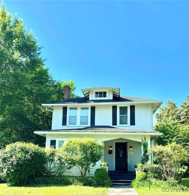 110 Gatewood Ave, Crewe, VA 23930 - traditional style home featuring a chimney, stucco siding, a porch, and a front yard