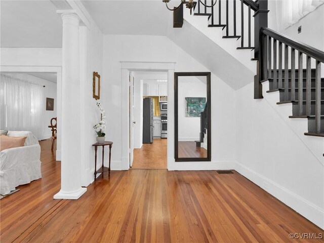 110 Gatewood Ave, Crewe, VA 23930 - entryway featuring ornate columns, hardwood / wood-style flooring, stairway, and baseboards